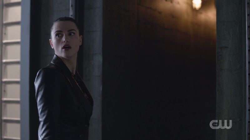 Lena looks back before entering the secret passageway