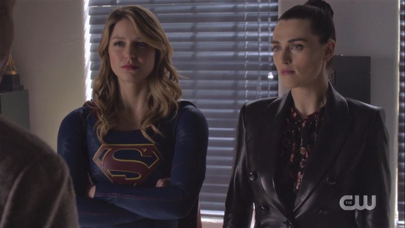 Supergirl crosses her arms, Lena's wearing a leather jacket, all is gay and beautiful