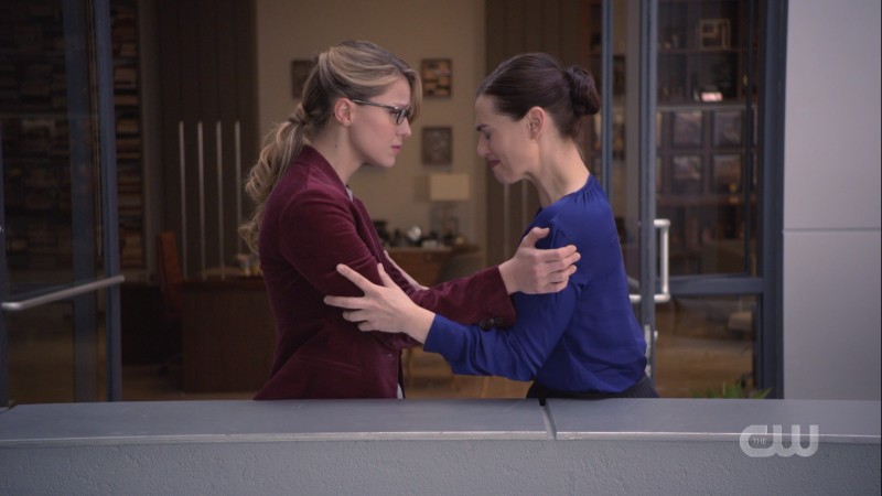 Kara holds Lena's arms.
