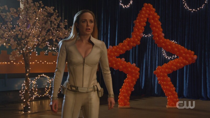 Sara watches in horror in her white canary suit