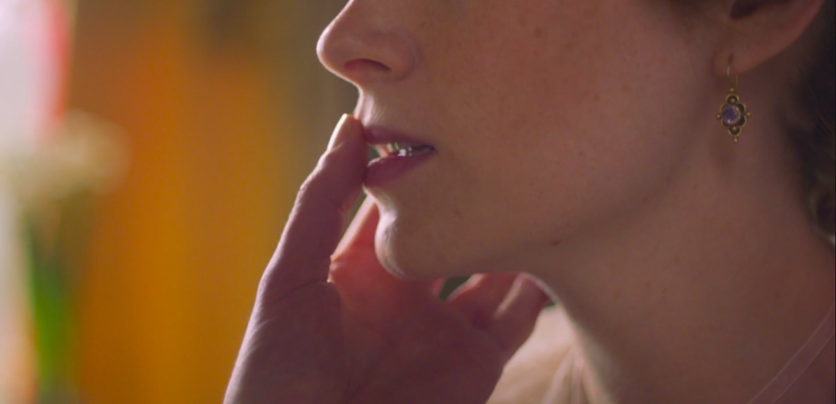 Anne Lister touches a thumb to Anne Walker's mouth and says,