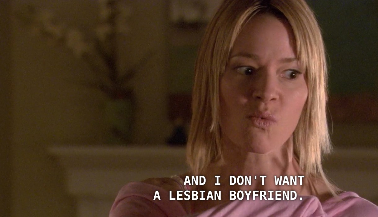 Alice, wearing a pink shirt and poker straight blonde hair, purses her lips and says, "I don't want a lesbian boyfriend."