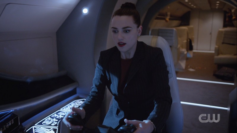 Lena holds the controllers in the cockpit