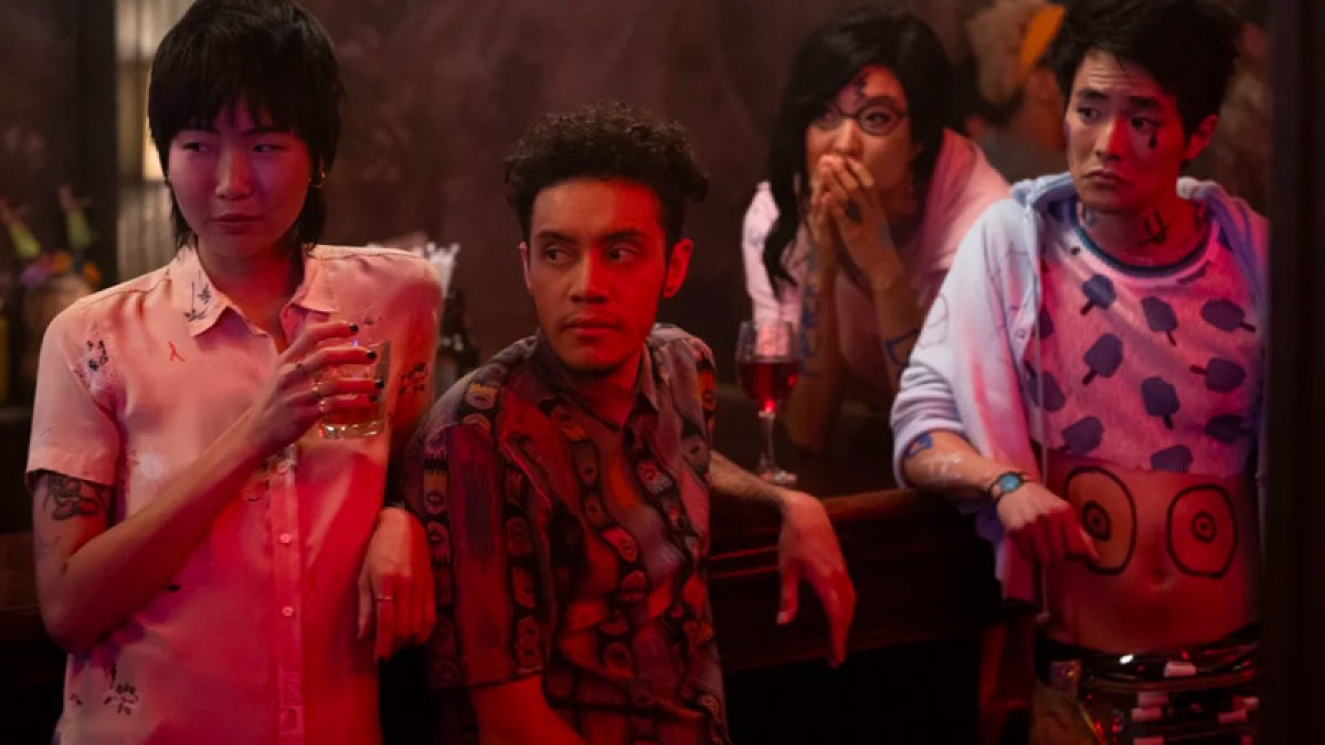 Image: four hipsters at a bar at night