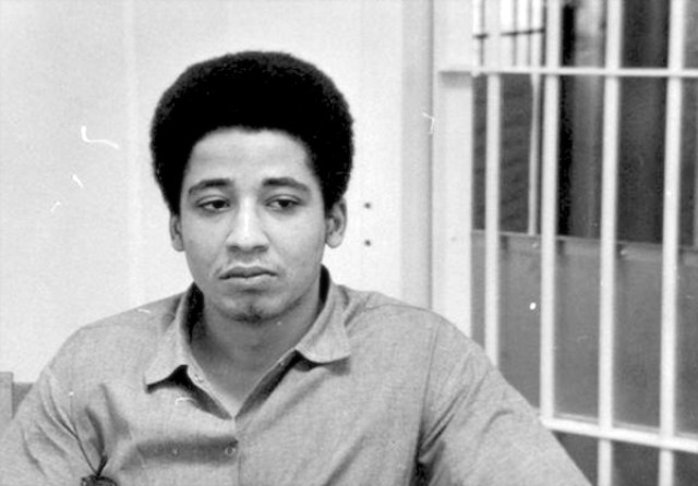 A photo of George Jackson, founder of Black August, incarcerated inside his prison cell.