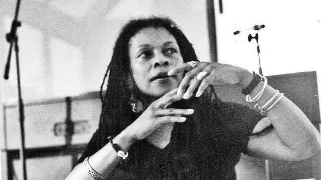 A black and white photo of Assata Shakur from the 1970s.