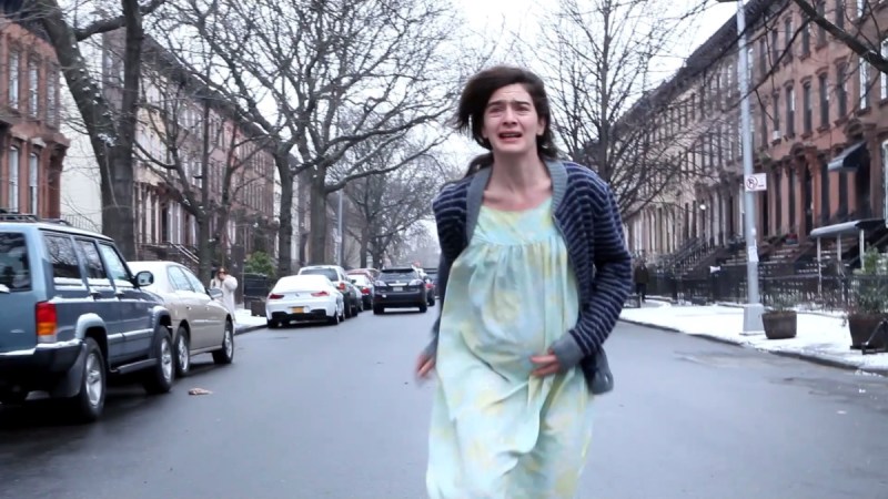 Queer horror to stream: Lyle. A pregnant Gaby Hoffman runs down a Brooklyn street looking terrified.