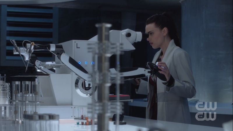 lena looks through a microscope