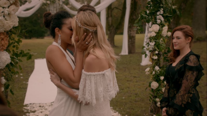freya and keelin kiss at their wedding with hope in the background