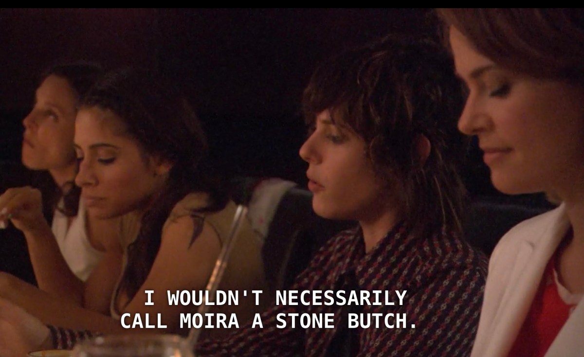In order from left to right, Dana, Carmen, Shane, and Alice sit at a restaurant dinner table. Shane says, "I wouldn't necessarily call Moira a stone butch."