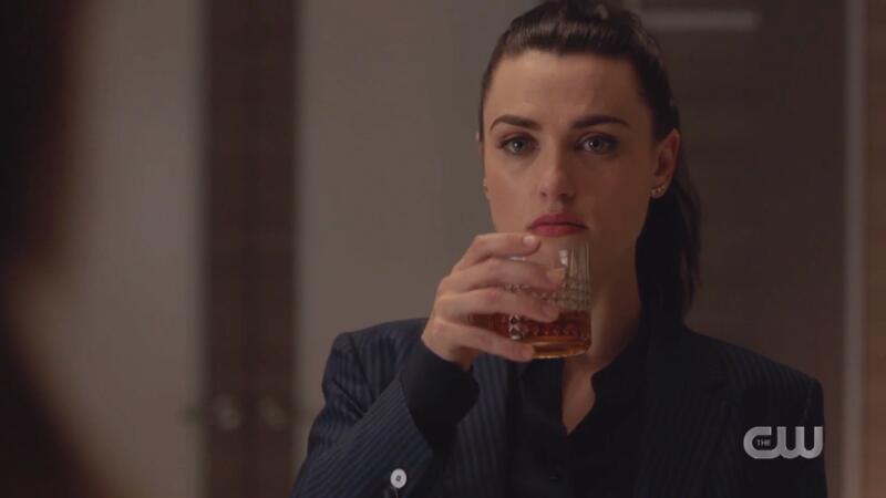 Lena sips her drink menacingly