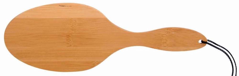 an oval wooden paddle with a loop for hanging