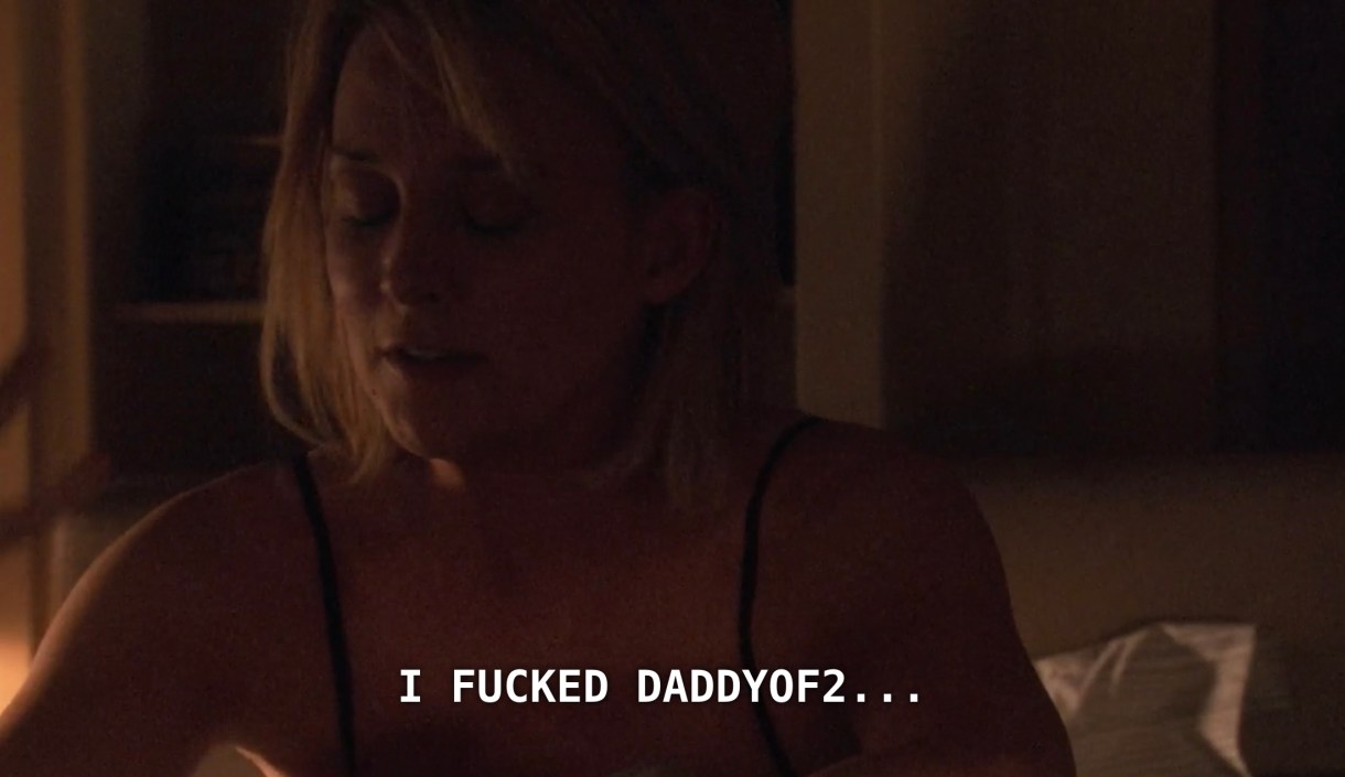 Tina is wearing a black tank top and is a dimly lit bedroom. She says, "I fucked DaddyOf2..."