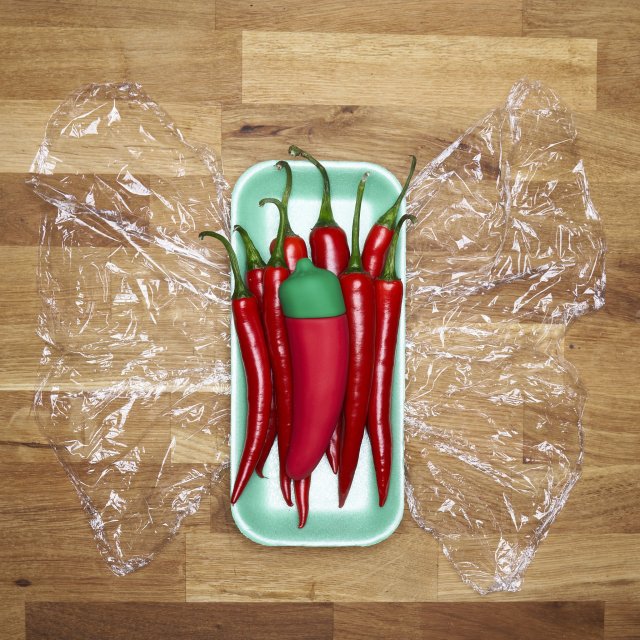 a pepper-shaped vibrator in a tray of real peppers