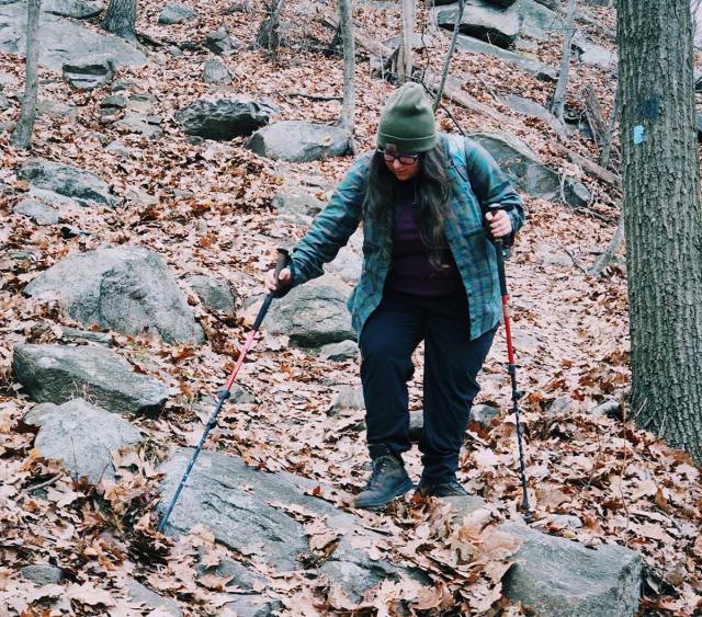 Vanessa hiking with poles.