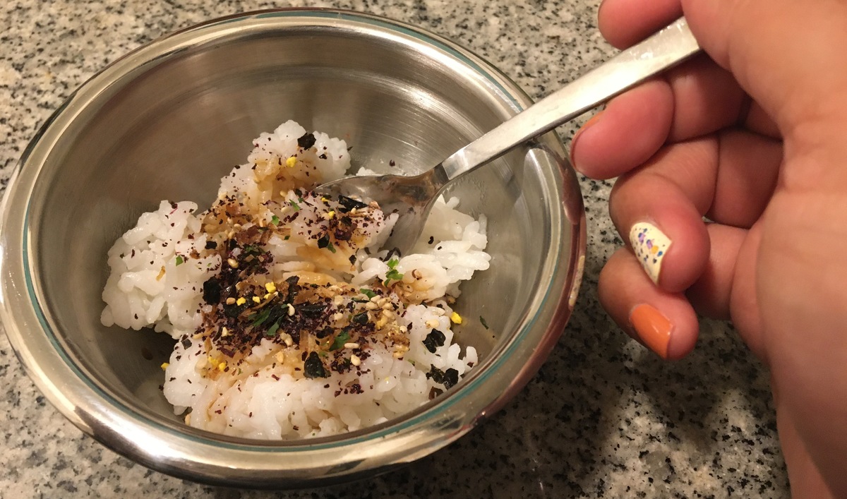 bowl of rice with toppings and spoon