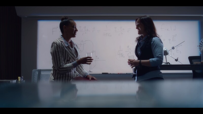 Samantha Burns and Amanda wear business outfits in a lab