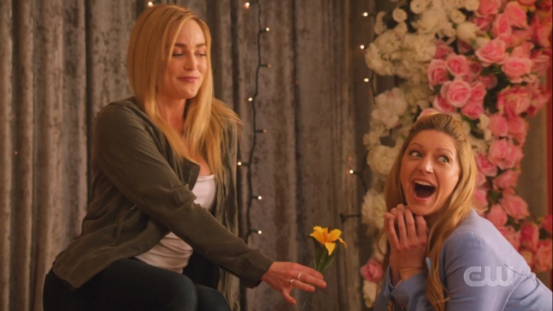 sara gives ava a flower in the photo booth