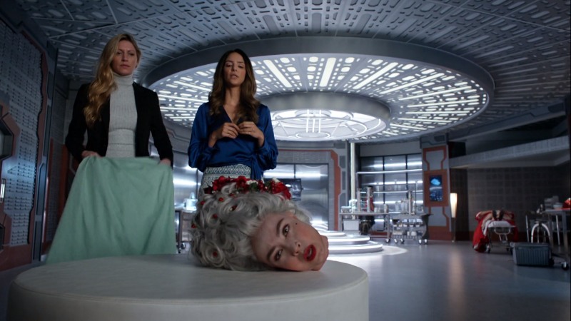 ava and zari look at marie's sentient severed head