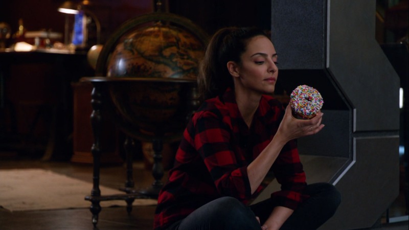 zari in a flannel with a donut
