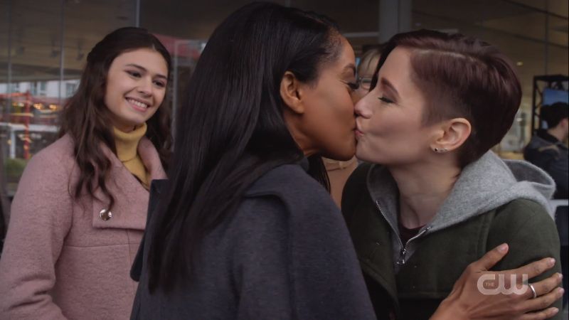 nia smiles as alex and kelly kiss