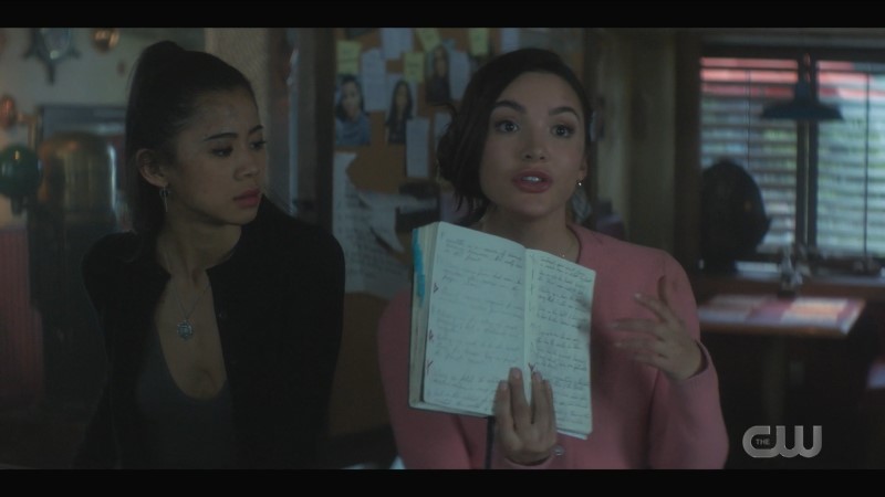 Bess holds up a notebook while George looks on incredulously. 