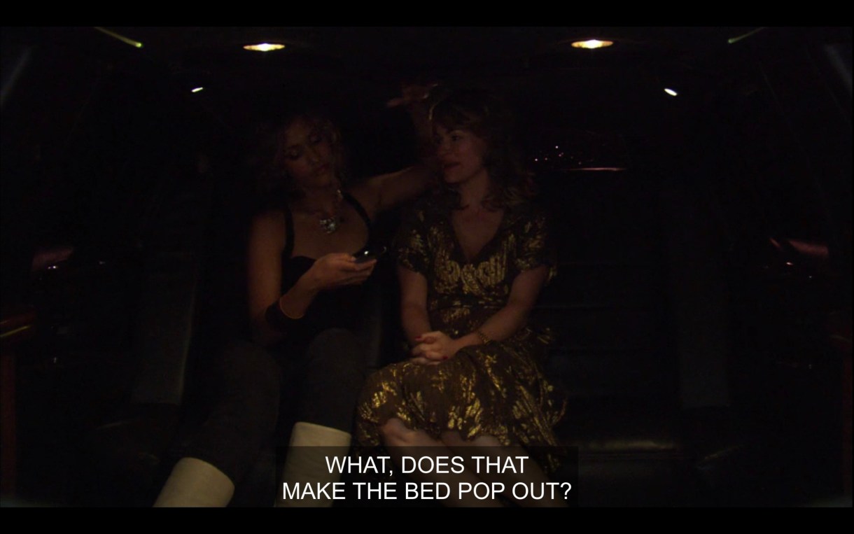 Papi and Alice sit in the backseat of a car. Alice says, "What, does that make the bed pop out?"