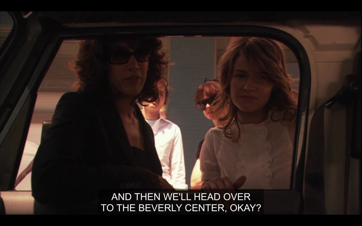 Bette, Alice, Jenny, and Max look into the window of Shane's car to talk to her. Bette says, "And then we'll head over to the Beverly Center, okay?"