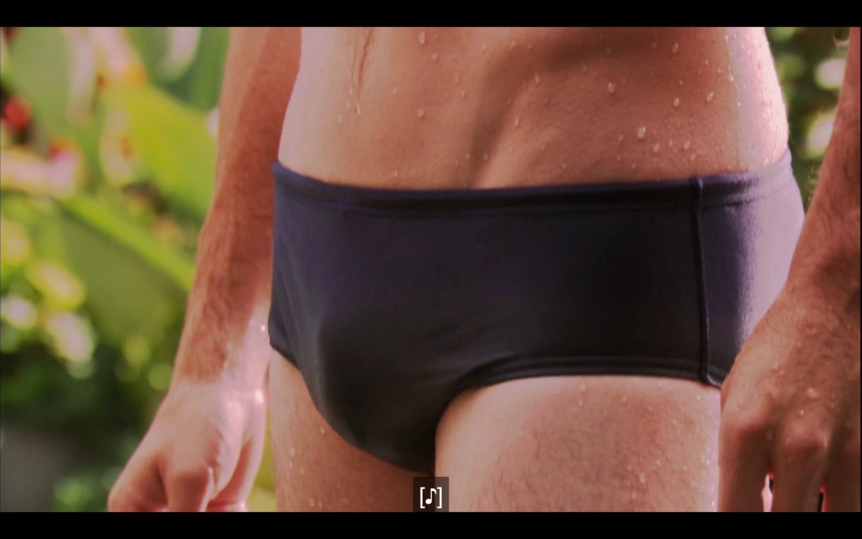 Close-up shot of a guy's bulge in his black Speedo swimsuit.