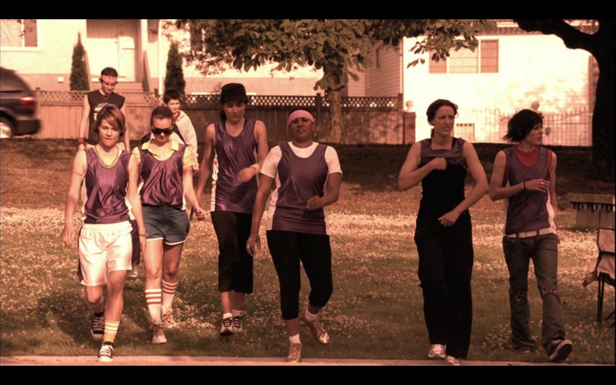 The whole crew (Alice, Jenny, Helena, Kit, Bette, and Shane) are wearing purple jerseys and walking onto the basketball court, looking way more confident than they probably should be. 