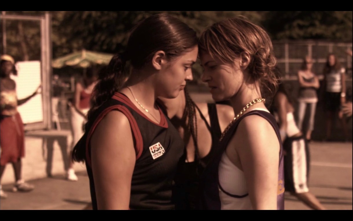 Alice staring down and standing VERY close to one of her opponents on the basketball court.