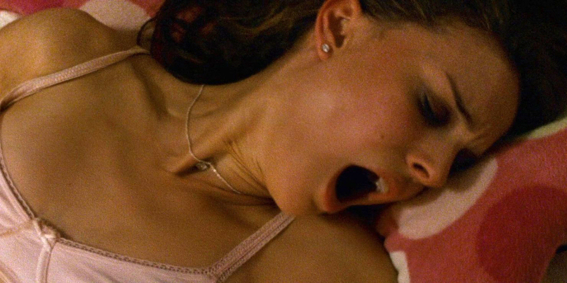 Natalie Portman in a pink bra opens her mouth in orgasm.