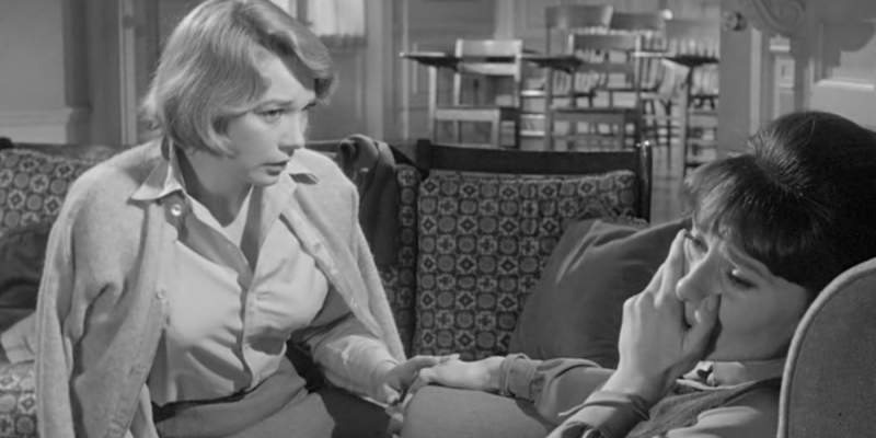 A still from The Children's Hour. Shirley MacClaine looks at Audrey Hepburn and holds her hand.