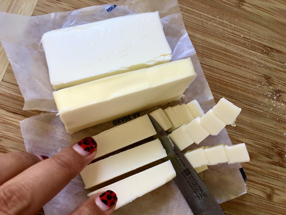 stick of butter getting cut by a knife