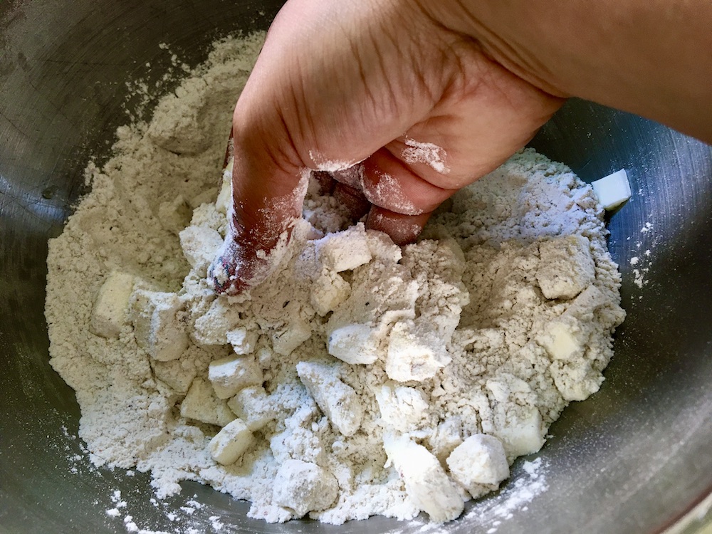 hand mixing up flour