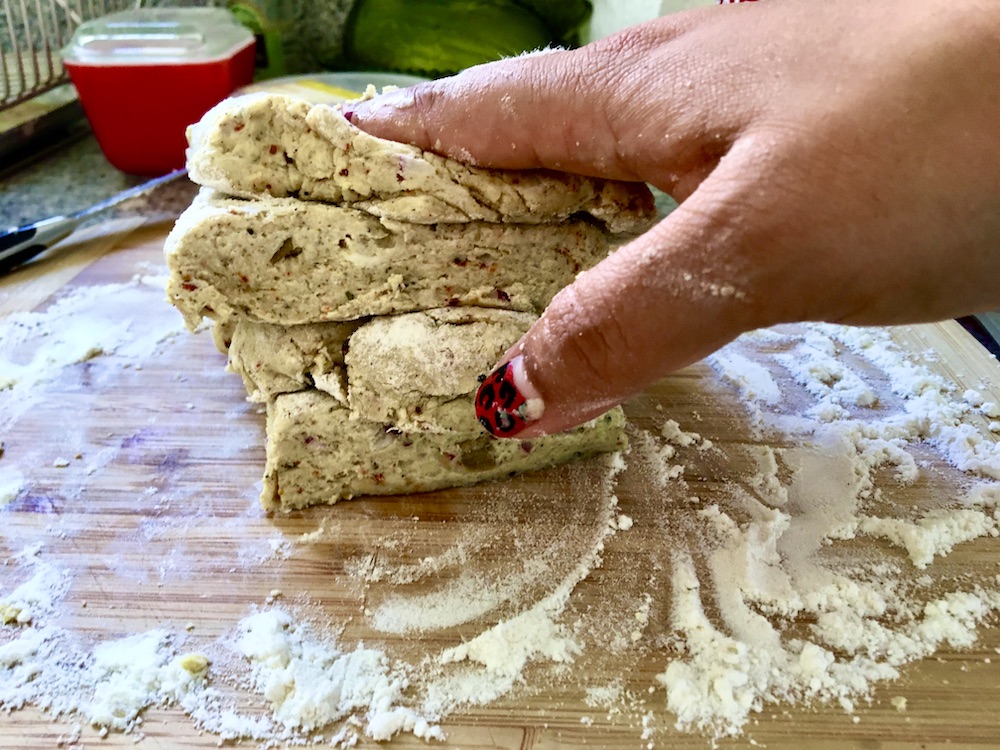 hand smashing pile of dough