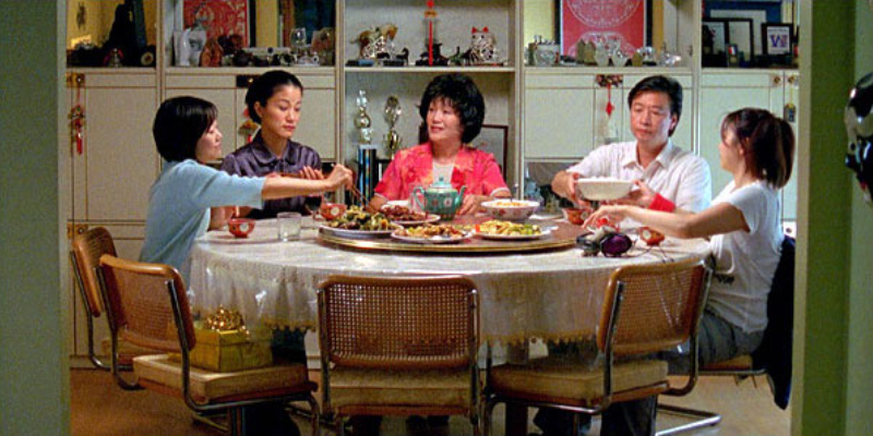 A family sits around a table eating food.