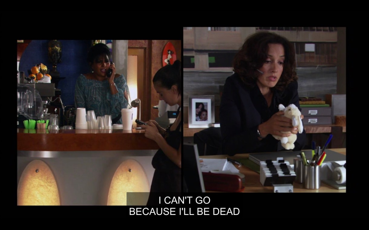 Side-by-side visual of Kit and Bette talking on the phone. Kit is in a blue top standing behind the counter at The Planet. Bette is wearing a black blazer and is sitting at her desk, talking into a headset and holding a small white stuffed bunny. "I can't go because I'll be dead."