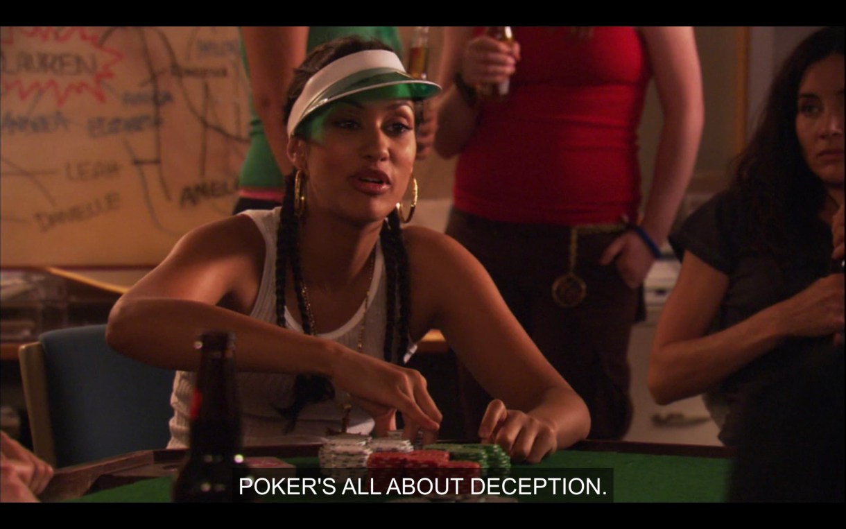 Papi is in a white tank top and a green poker visor, sitting at a poker table with a stack of poker chips in front of her. She says, "Poker's all about deception."