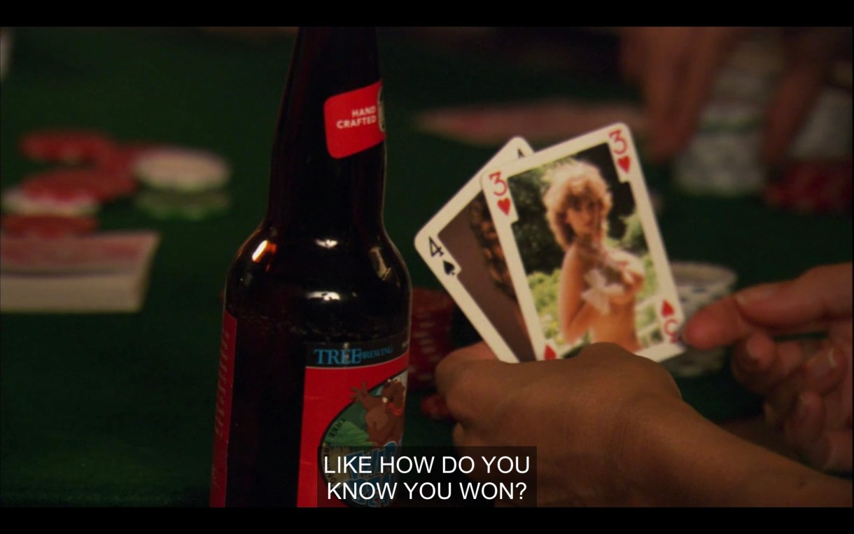 A pair of hands holding 2 playing cards (a 4 of spades and a 3 of hearts) next to a beer bottle on a poker table. "Like, how do you know you won?"