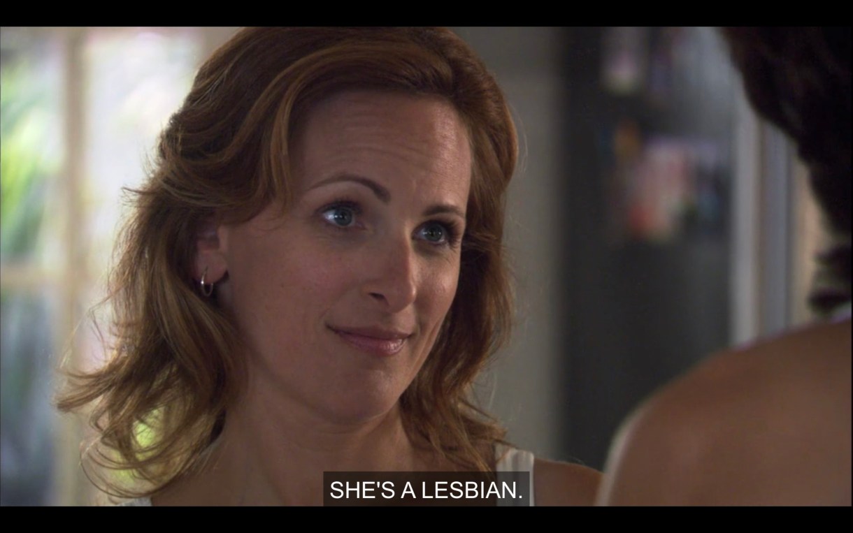 Jodi looking at Bette saying "She's a lesbian." Close-up head shot.