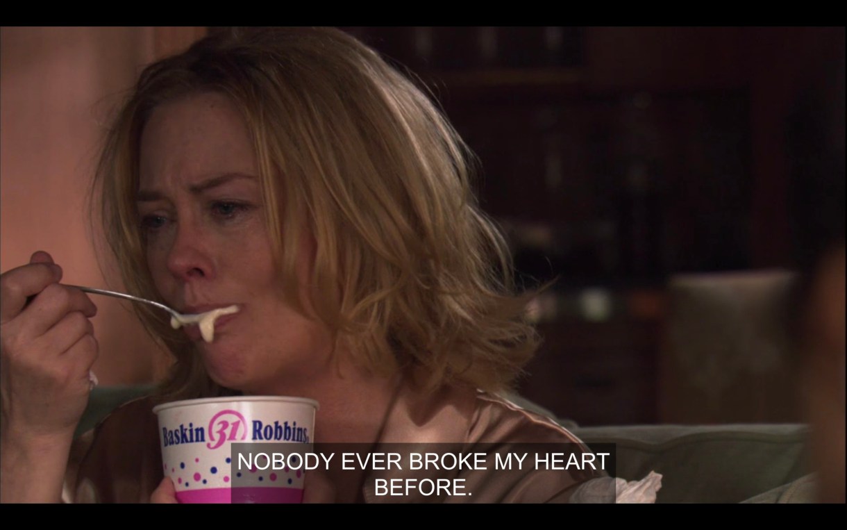 Phyllis is crying and eating ice cream out of a Baskin Robbins cup, saying "Nobody ever broke my heart before."