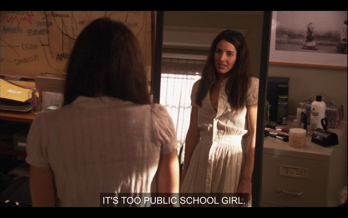 Helena has been trying on outfits. In this one, she's wearing a short-sleeve white dress and looking in a full length mirror saying "It's too public school girl."