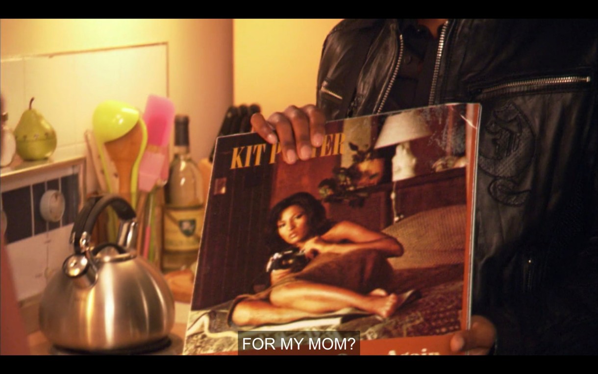 Kit's record album, featuring a picture of her spread out on a bed. 