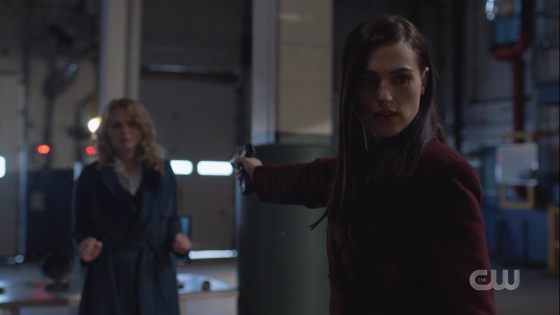 lena holds a gun to eve while supporting kara