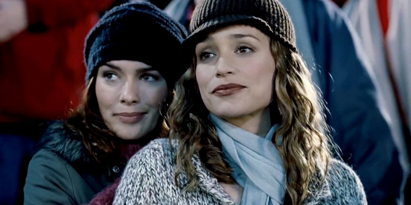 A still from the 38th best lesbian movie of all time Imagine Me & You. Two women in knit beanies stand close together.