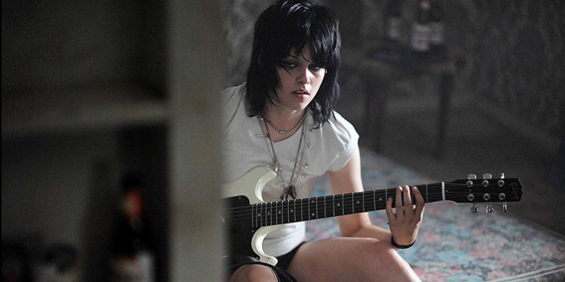 Kristen Stewart as Joan Jett playing guitar.