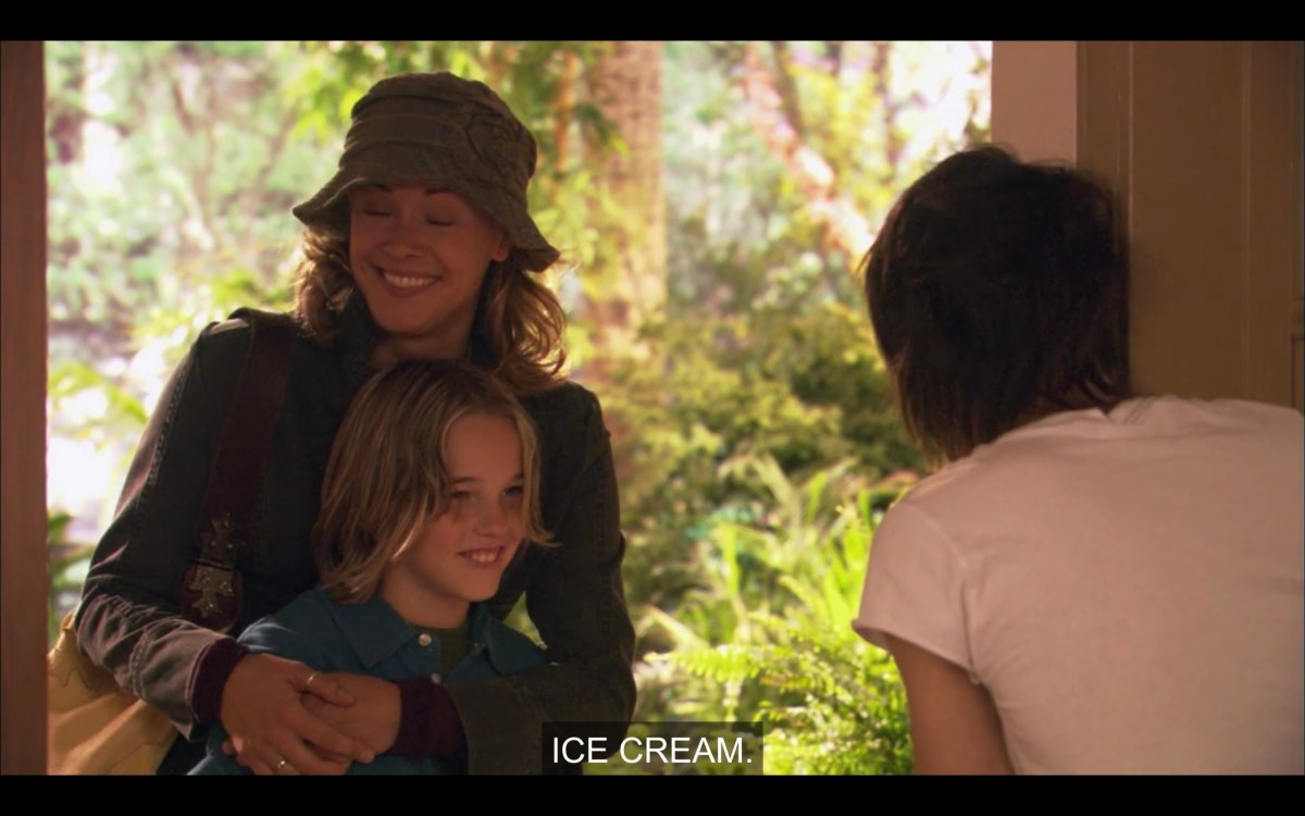 Shane has just opened the front door to find Paige (who is wearing a bucket hat) and Jared. Shane says, "Ice cream." 