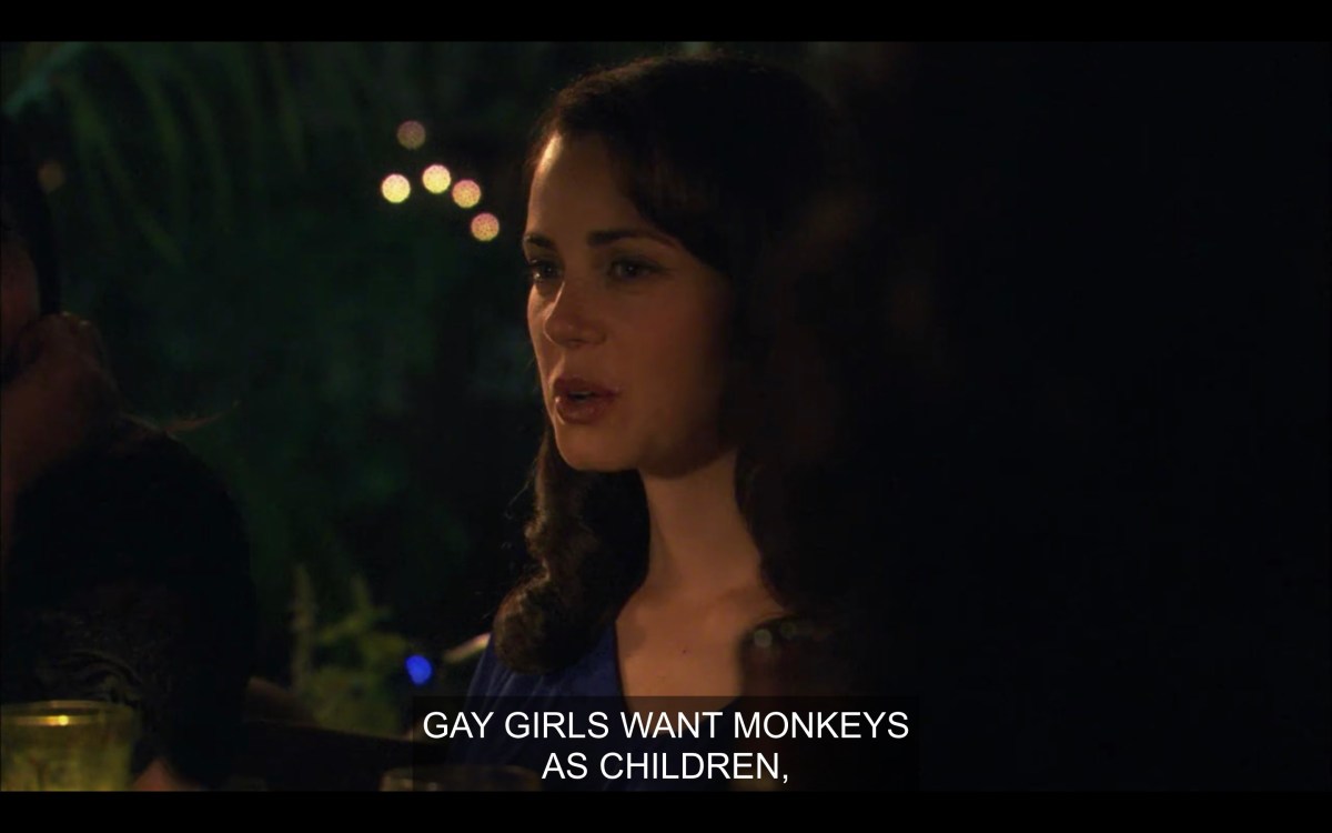 Catherine sitting at an outdoor dinner party table. She says, "Gay girls want monkeys as children."
