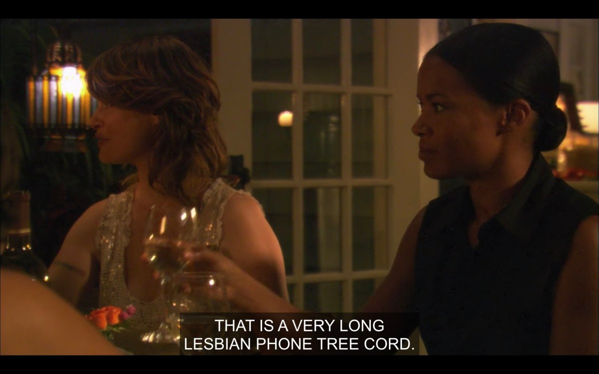 Tasha and Alice sitting next to each other at the dinner table. Tasha is holding a glass of white wine. "That is a very long lesbian phone tree cord."